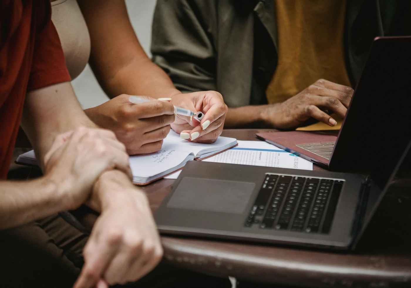 A team planning a launch around laptops, notebooks, and project documents